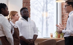 Hospitality leader conducting on the job training with front line staff