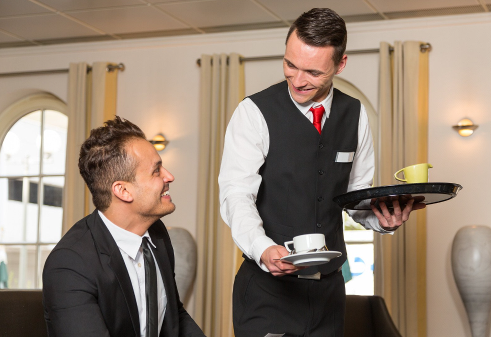 Server successfully following standards on SOP Manual while smiling at guest.